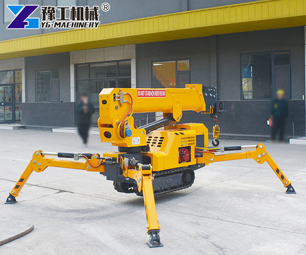 Small crawler crane working in an indoor factory